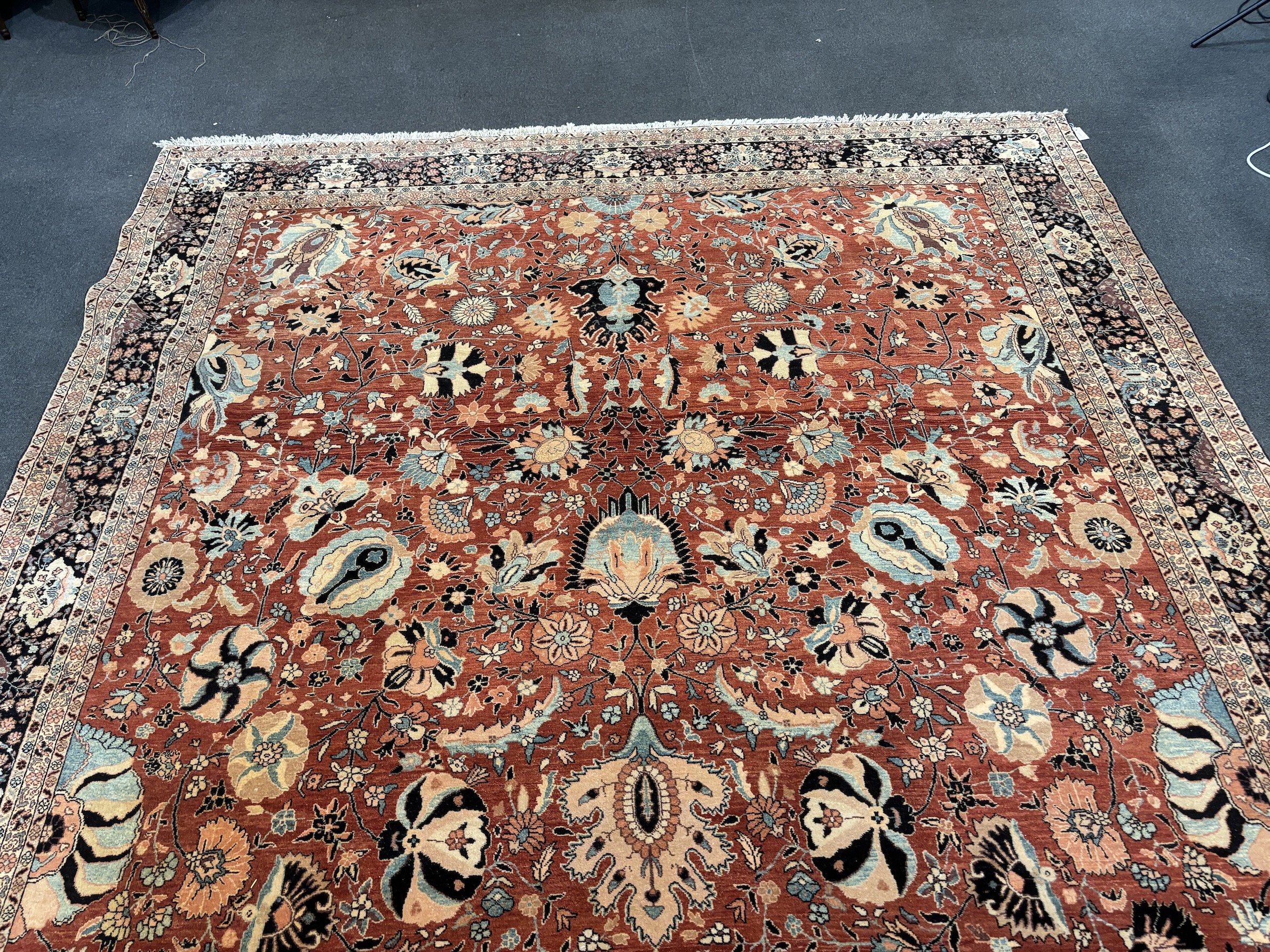 A Tabriz brick red ground gallery carpet 575 x 300cm